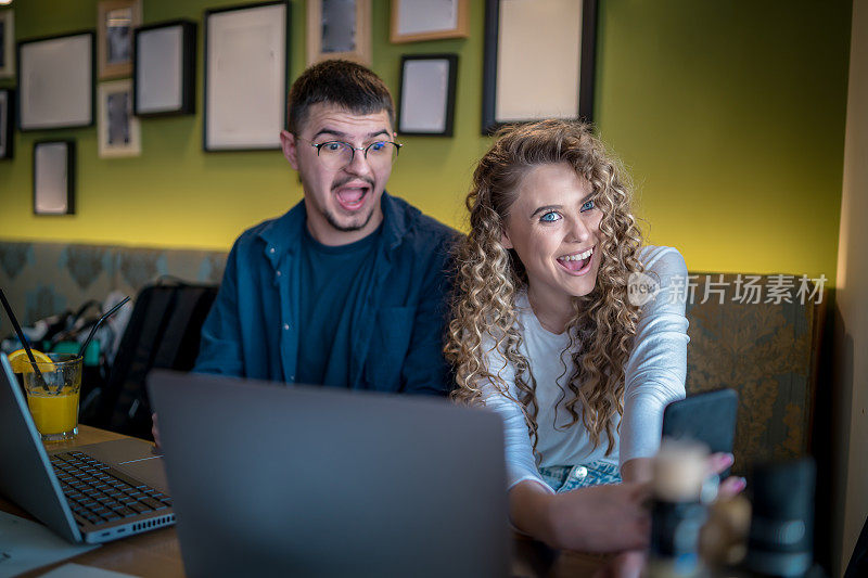 Business people working together at a café using their laptops